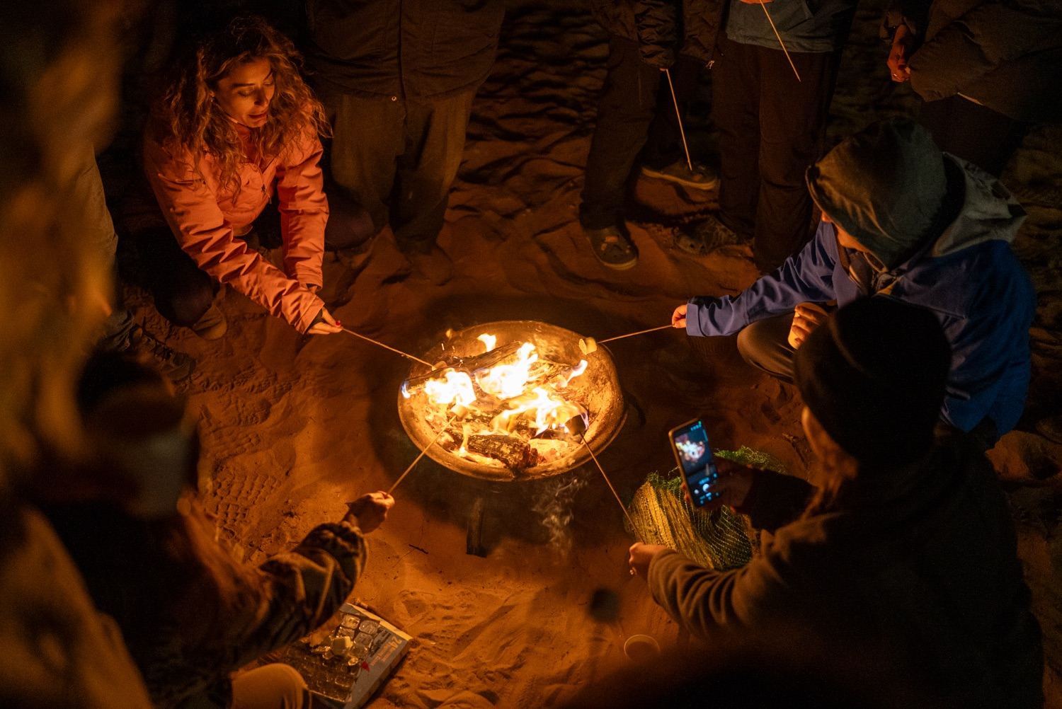 Guests around a bonfire on an overnight camping trip at Al Quaa, Abu Dhabi